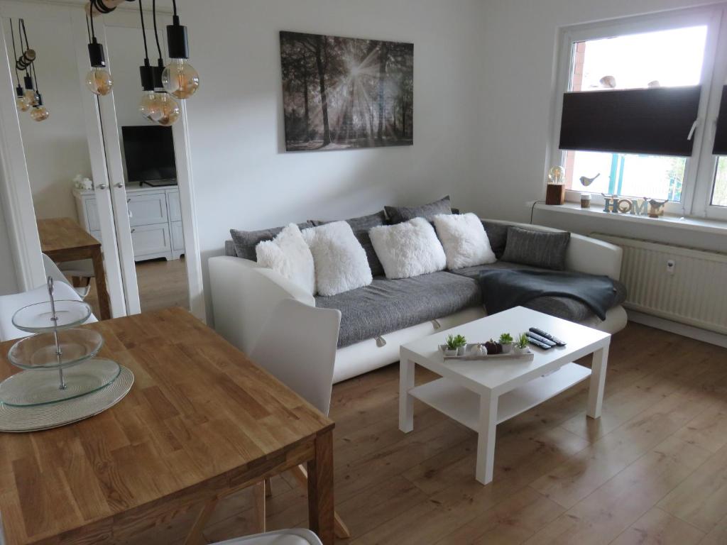 a living room with a couch and a table at Wohnung am Tor zur Lewitz-Erdgeschoss in Banzkow