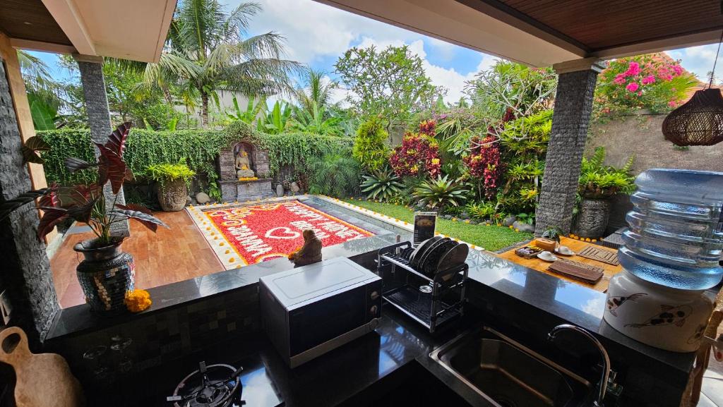 a kitchen with a counter top and a garden at Ubud Paradise Villa in Ubud