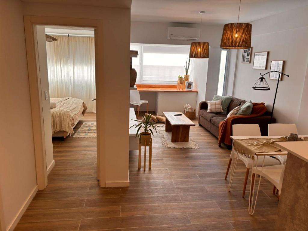 a living room with a couch and a table at Pirca NQN in Neuquén