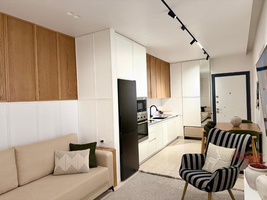 a living room with a couch and a kitchen at Endis House in Shëngjin