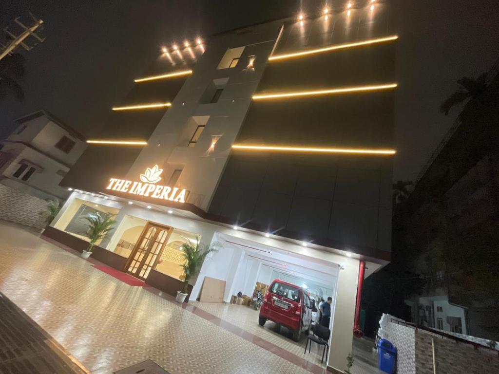 a hotel with a car parked in front of a building at The Imperia in Guwahati