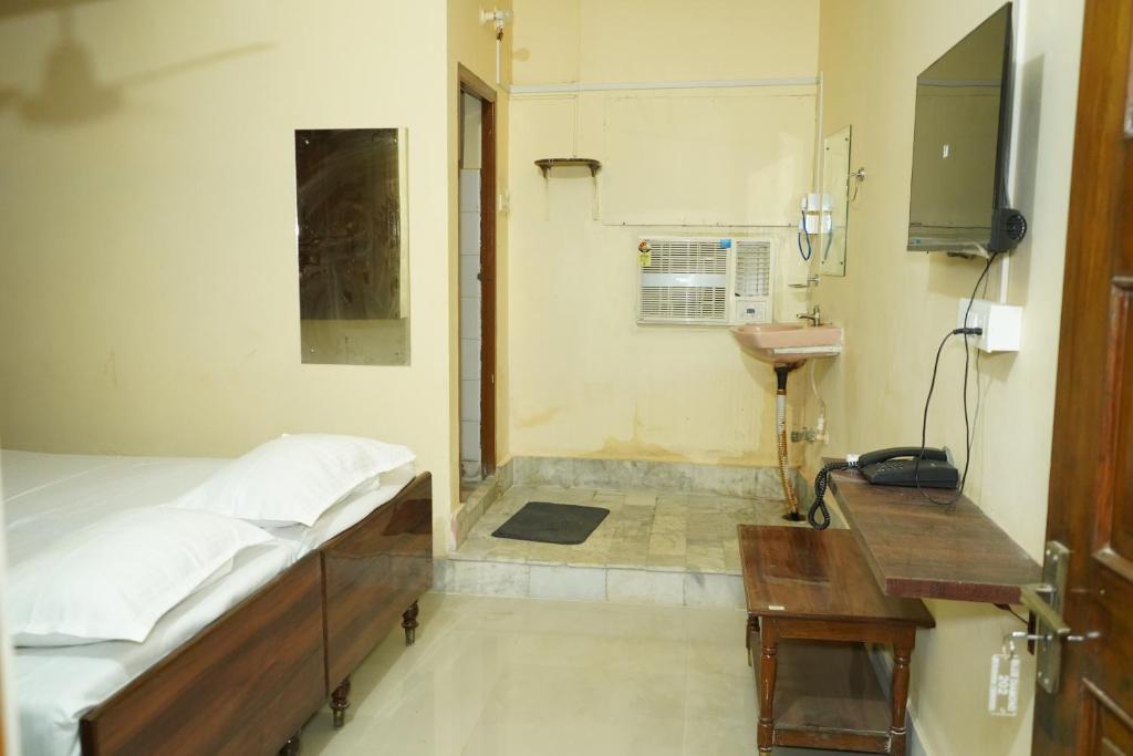 a hospital room with a bed and a desk at Hotel BLUE DIAMOND in Begusarai