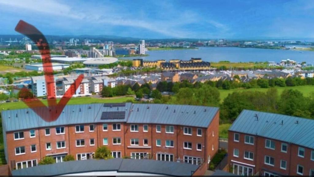 a view of a city with a building and a body of water at 4 bed Townhouse with spectacular views 4 miles from Cardiff 10min drive or train journey to city centre in Cardiff