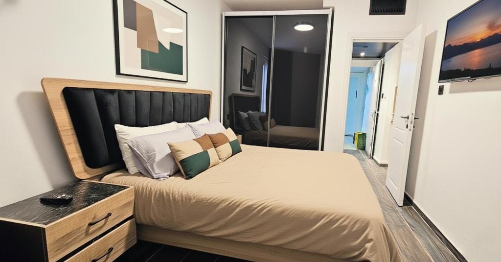 a bedroom with a large bed and a mirror at Tiberias Suite 411 in Tiberias