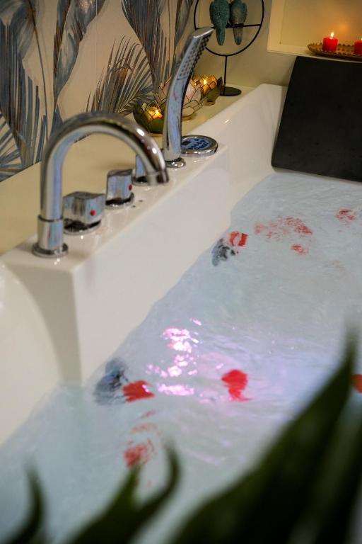 a bathroom sink with red paint on top of it at Attimo d'amore in Quinto Vicentino