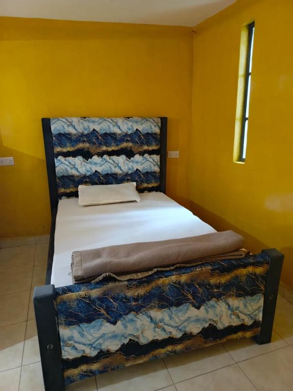 a bed in a room with two bunk beds at Kio Farm2 in Kiserian