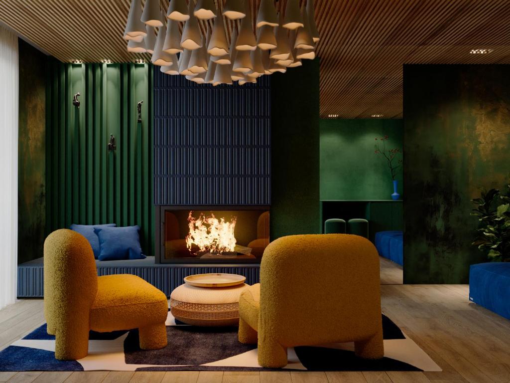 a living room with two chairs and a fireplace at Stara Pravda Hotel - Vykrutasy in Bukovel