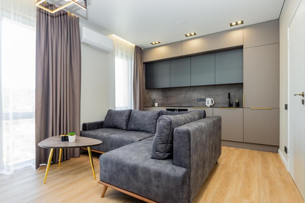 a living room with a couch and a table at Baltic Harmony Apartments in Palanga