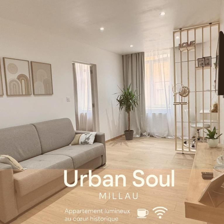 a living room with a couch and a table at UrbanSoul Millau in Millau
