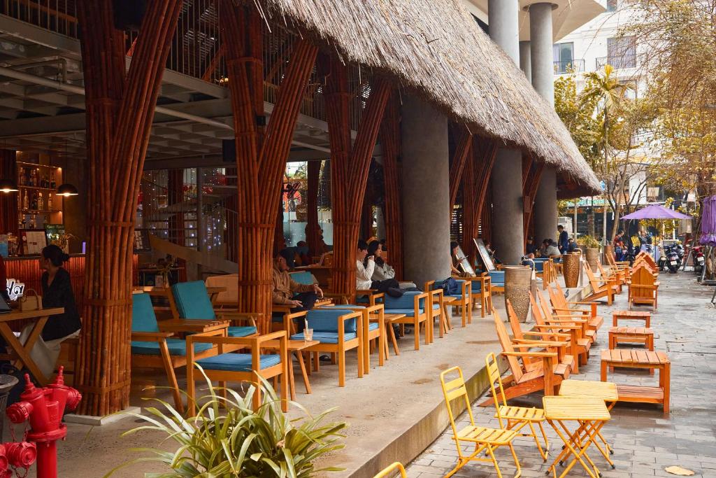 a row of chairs and tables in a restaurant at Avatar Danang Hotel in Danang