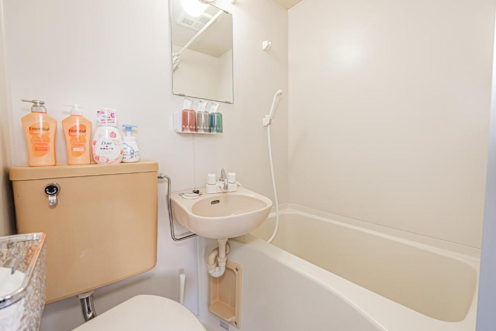 a bathroom with a sink and a toilet and a shower at sakura 201 in Tokyo
