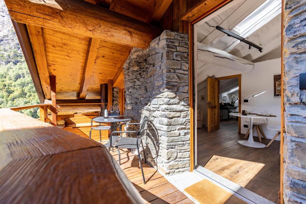 a bedroom with a stone fireplace in a house at Petit Câlin - Le Four des Alpes in Rhemes-Saint-Georges