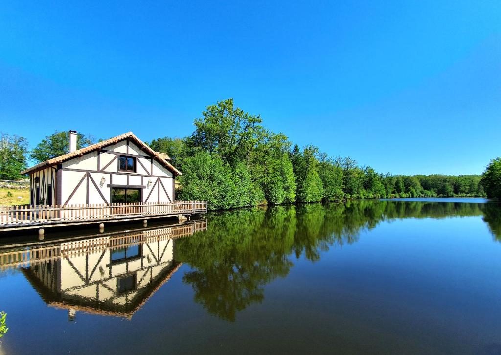 a house on a bridge over a lake at Chalet au bord d'un lac privé in Saint-Estèphe