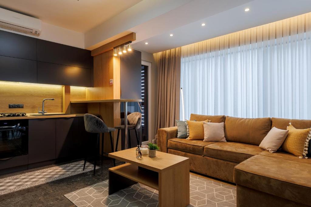 a living room with a couch and a table at Renest New York Skyline View in Chişinău
