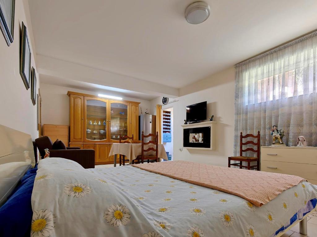a bedroom with a large bed and a table at Private Flatlet in a Villa with Pool - 6 Guests Max in Naxxar