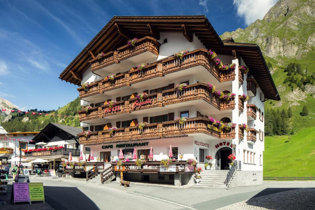 a large building with balconies and flowers on it at Wellnesshotel Engadin in Samnaun