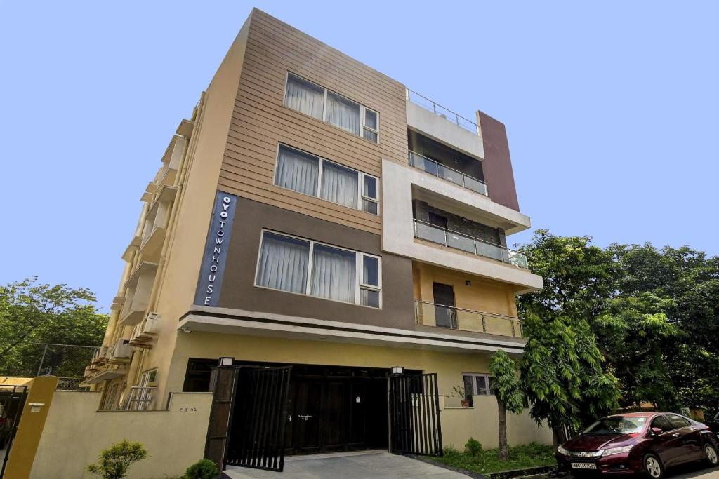 a building with a car parked in front of it at Super Townhouse All In One in kolkata