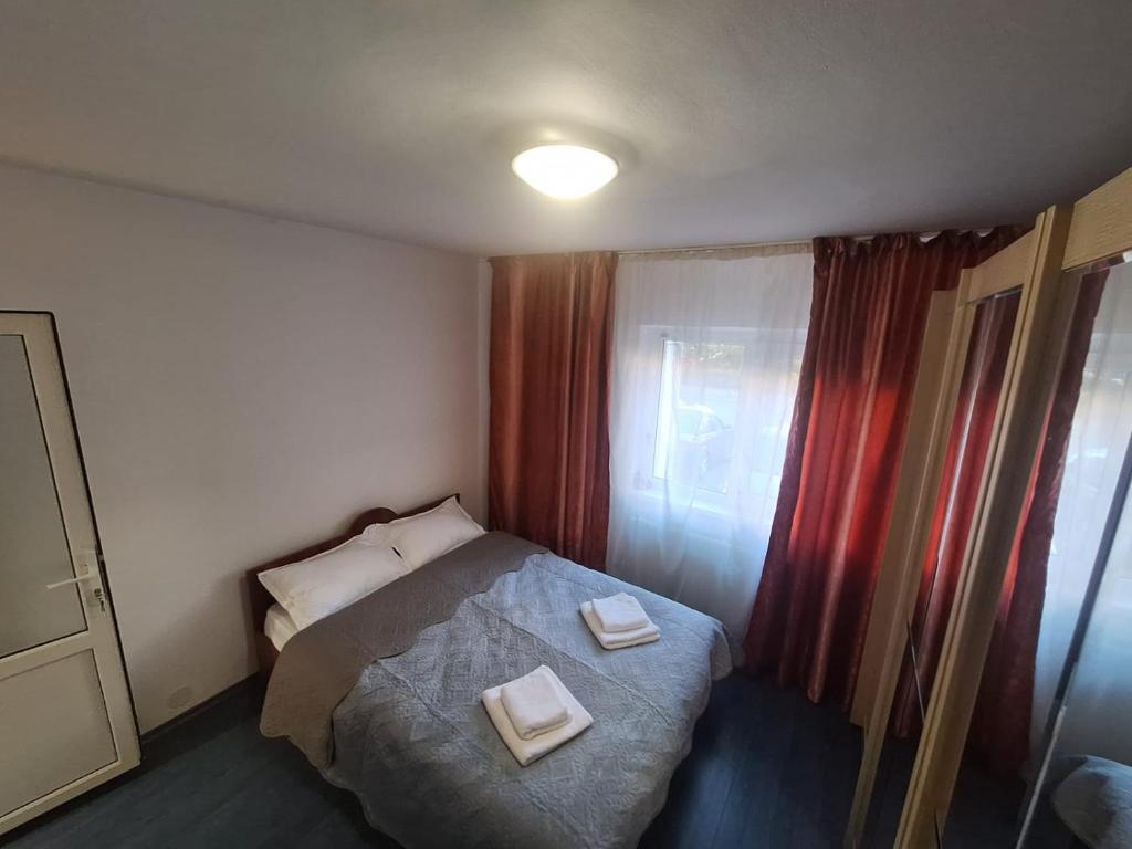 ein Schlafzimmer mit einem Bett mit zwei Handtüchern darauf in der Unterkunft ApartamentG4 in Craiova