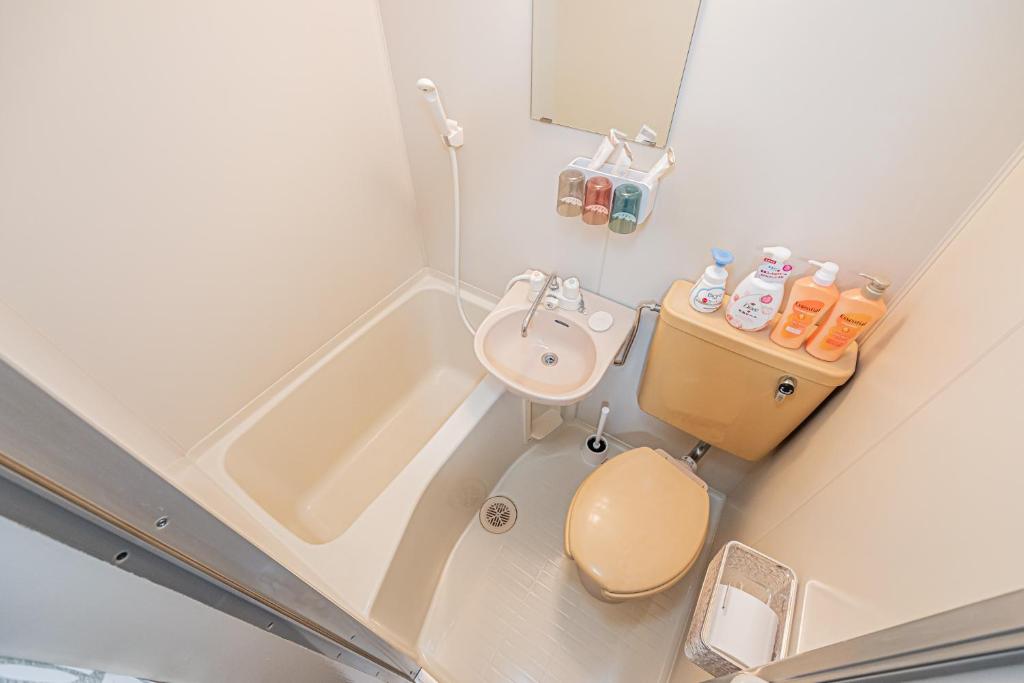 a small bathroom with a toilet and a sink at sakura 403 in Tokyo