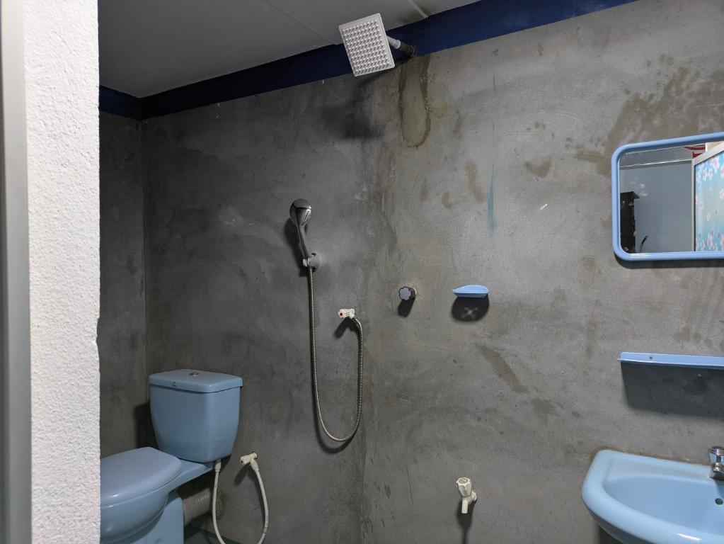 a bathroom with a shower with a toilet and a sink at Taj Mahal in Arugam Bay