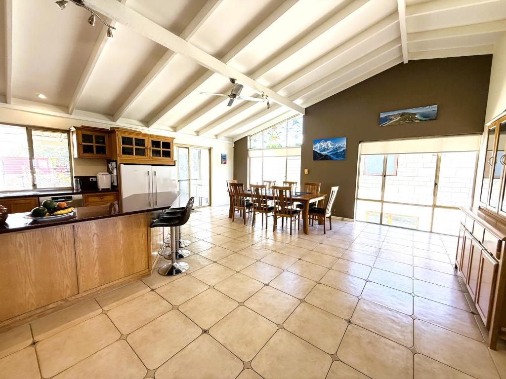 a large kitchen and dining room with a table at 24 Sorrento Seabreeze 5br Family Seaside Home in Perth