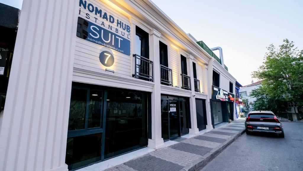 a building with a sun sign on the side of a street at Nomad Hub Suit İstanbul in Istanbul