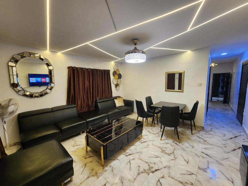 a living room with a couch and a table at CG Apartments Metro in Ikeja