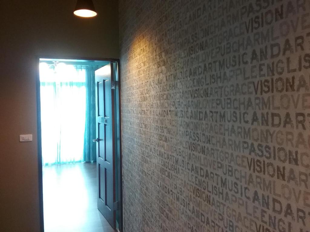 a hallway with a wall with writing on it at Slowly B&amp;B in Taitung City