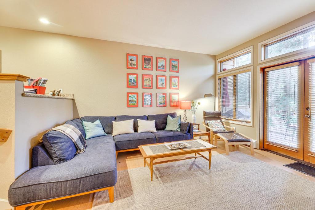 een woonkamer met een blauwe bank en een tafel bij 2 Mi to Diamond Peak! Corner-Unit Condo with Hot Tub in Incline Village