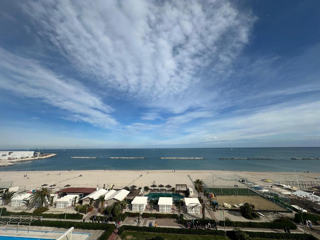 a view of a beach and the ocean on a cloudy day at Tra Cielo e Mare da Vale in Fano