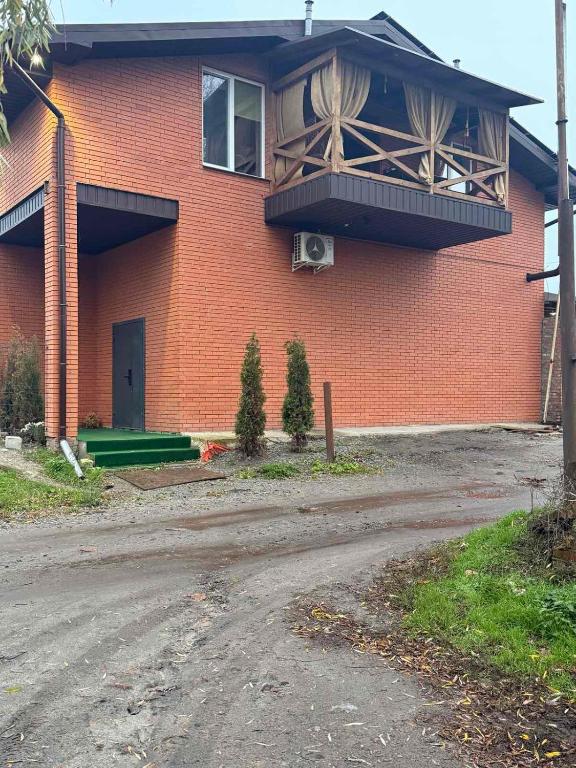 a brick building with a balcony on the side of it at River House Hotel in Romny