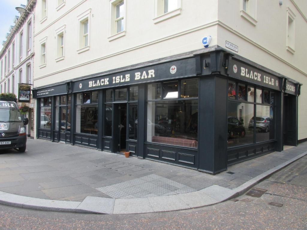 a black and white store front of a building at Black Isle Bar & Rooms in Inverness