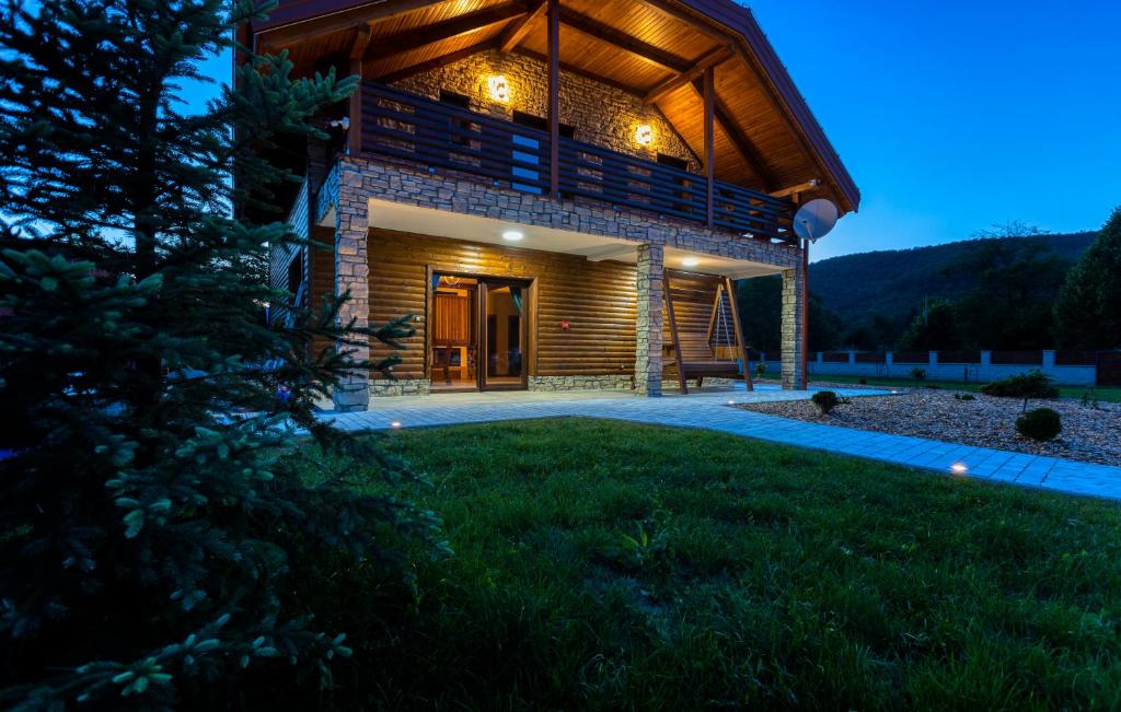 een groot huis met een terras 's nachts bij Villa D-IKA in Brušane