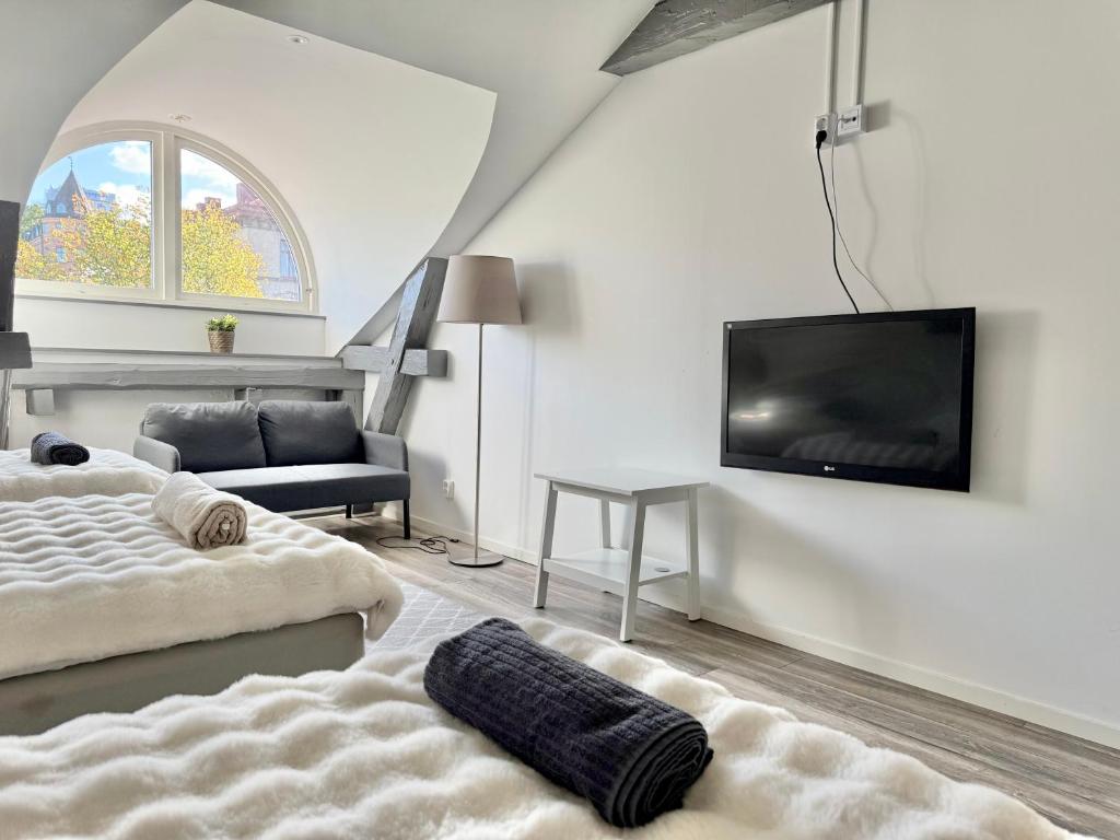 a living room with two beds and a flat screen tv at Worker & families Dream Apartment in the heart of Gothenburg in Gothenburg