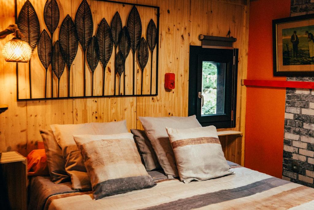 a bedroom with a bed with pillows on it at La Grange in Sablons