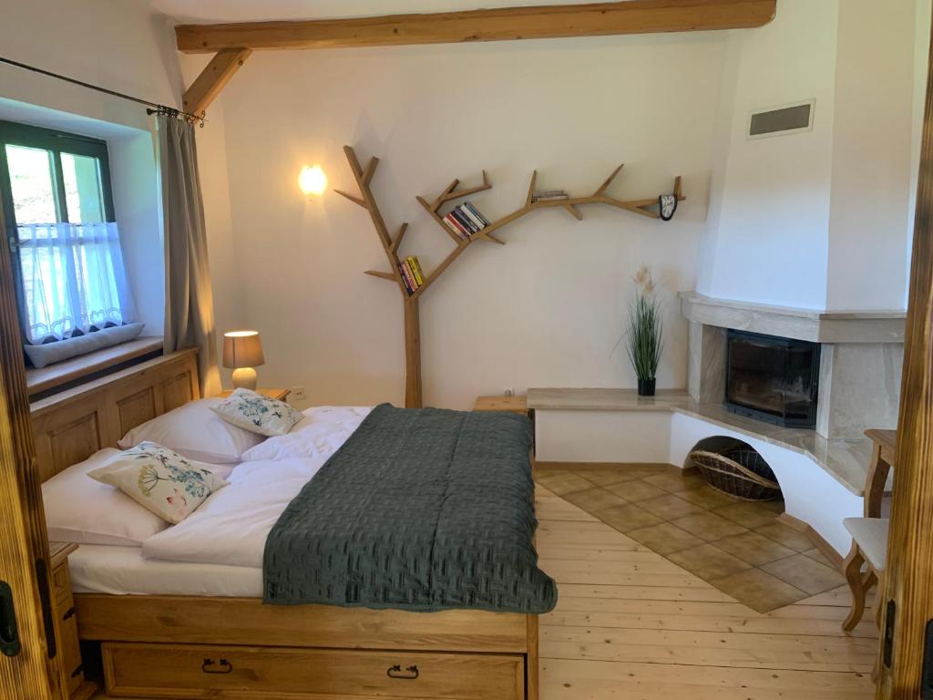 a bedroom with a bed and a fireplace at Dolina Rastoki in Koniaków