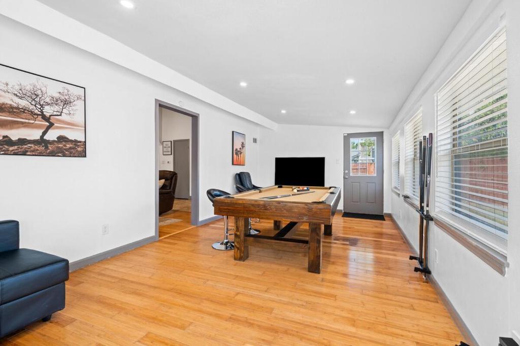 a living room with a ping pong table at Spacious 4BR w Fenced Yard in Round Rock