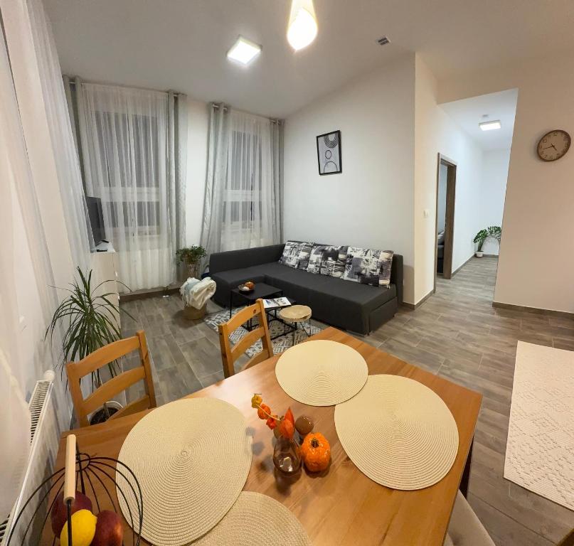 a living room with a table and chairs and a couch at Apartmán Nekonečno Jeseník in Jeseník