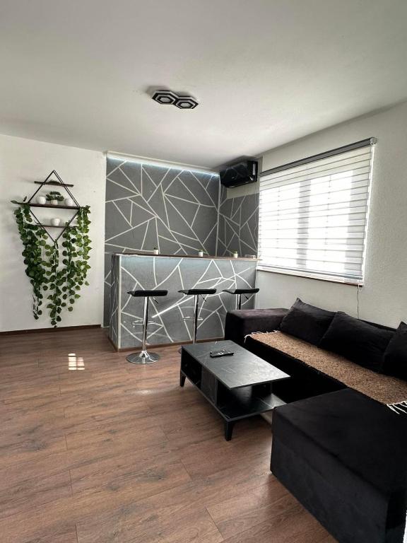 a living room with a couch and a table at Brick House in Kragujevac