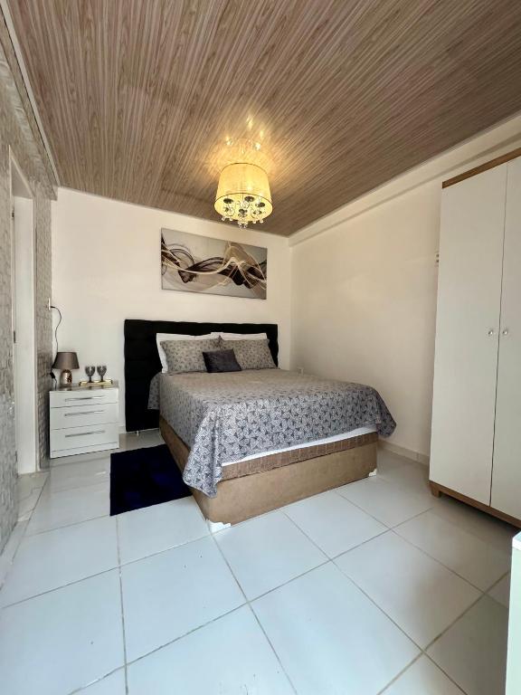 a bedroom with a bed and a wooden ceiling at Suite aconchego Belém in Una