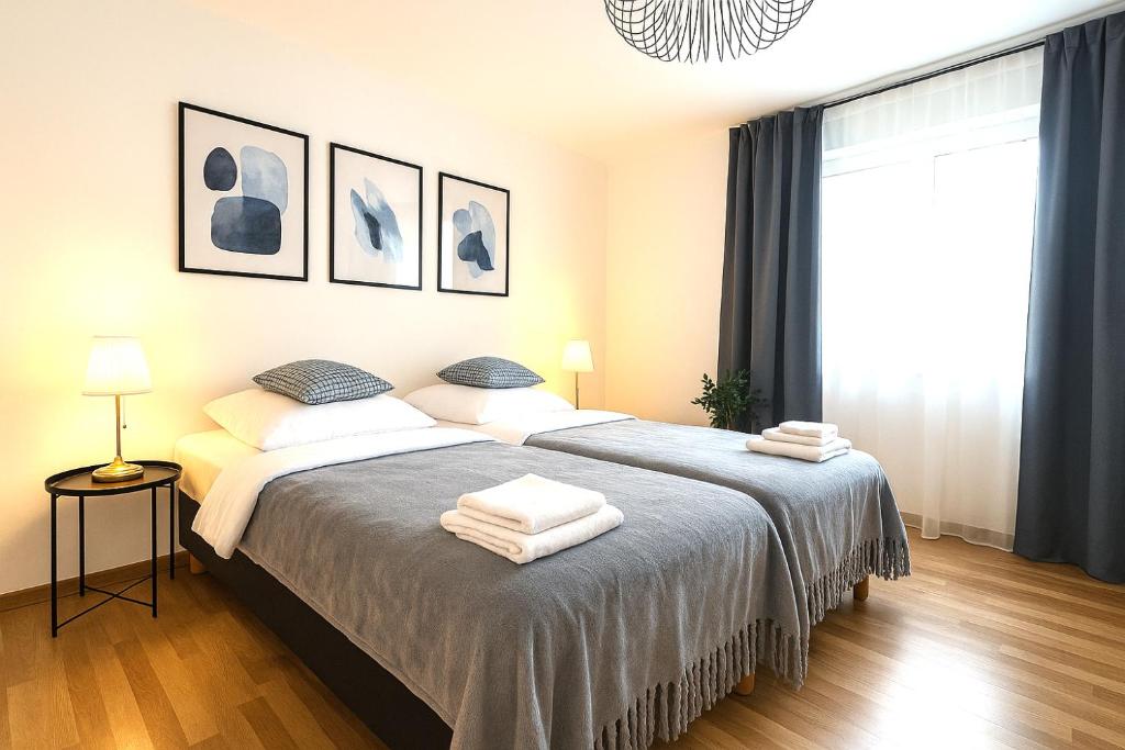a bedroom with two beds with towels on them at Airport Messe Hotel in Düsseldorf