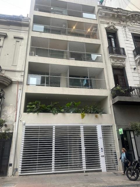 a building with a bunch of doors and plants on it at Suipacha Boutique in Buenos Aires
