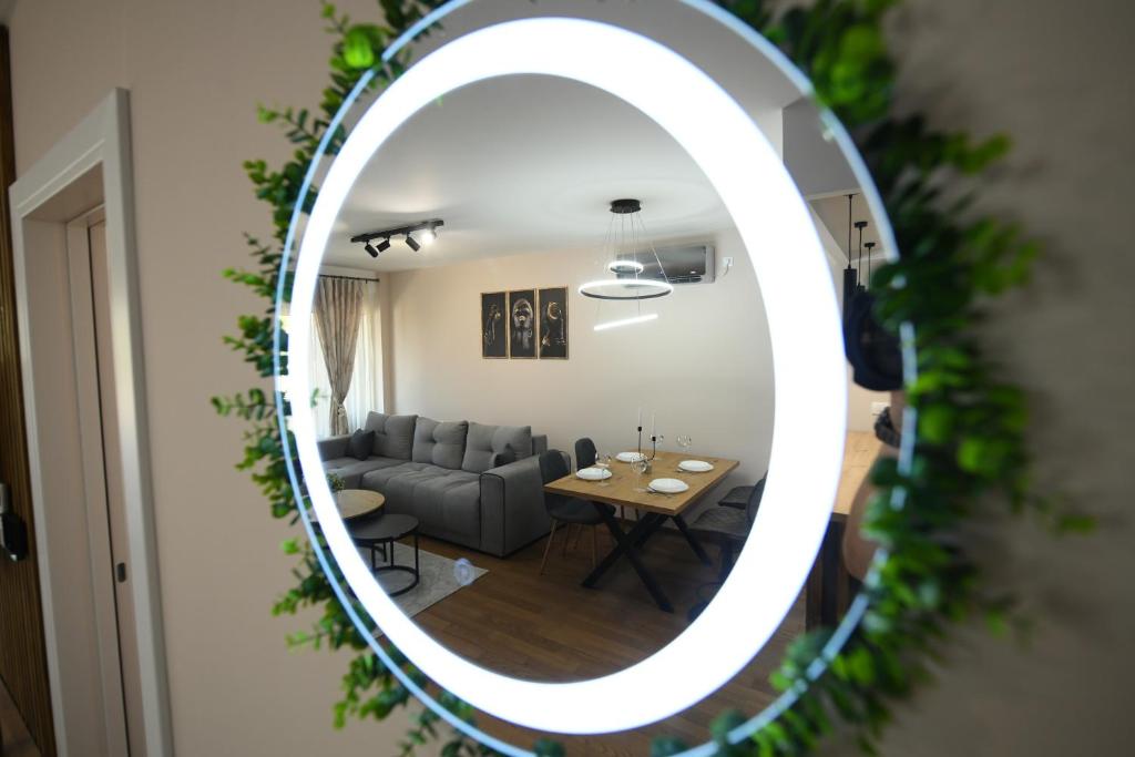 a mirror in a living room with a couch and a table at Cristal Palace Suites 003 in Kragujevac
