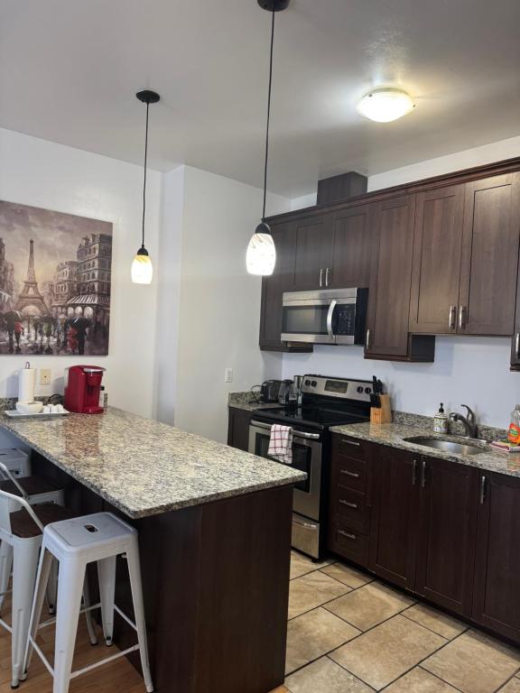 a kitchen with wooden cabinets and a counter top at Suitestay Apartments Hotel in Ottawa