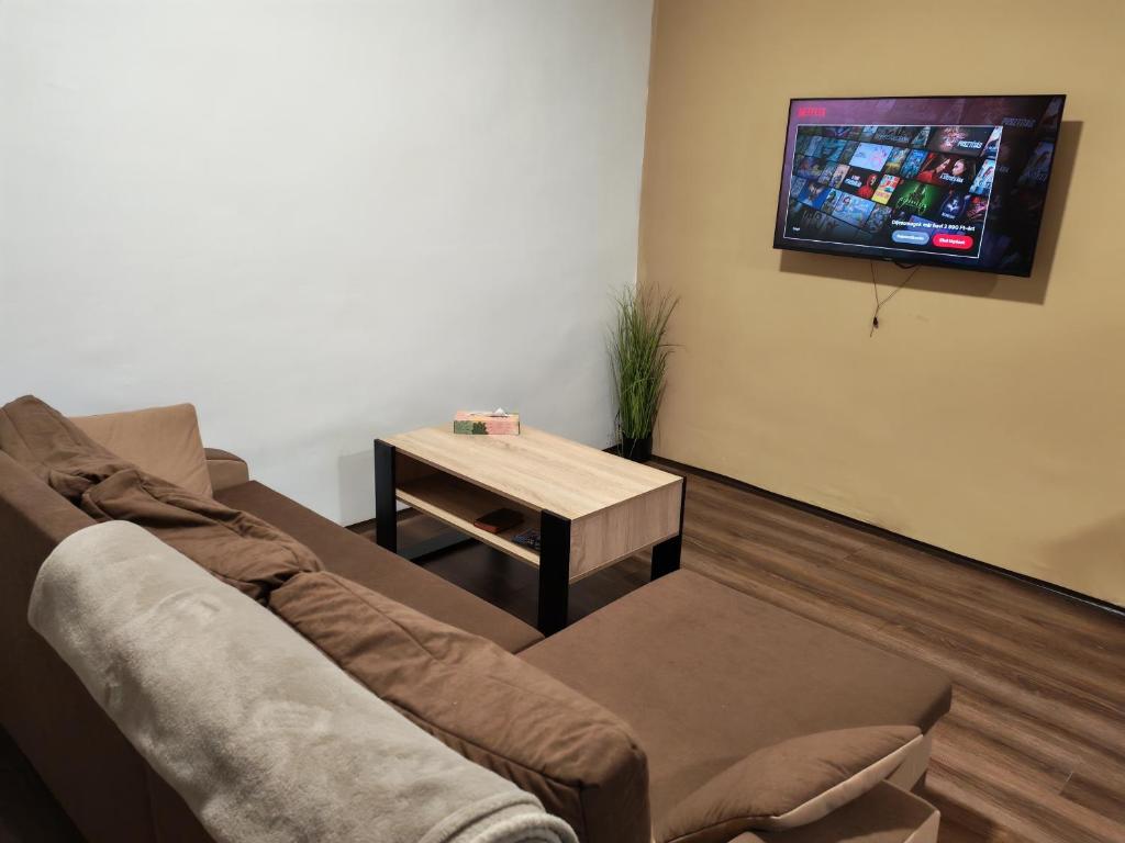 a living room with a couch and a table at Zo. Low Budget House in Bakonykoppány