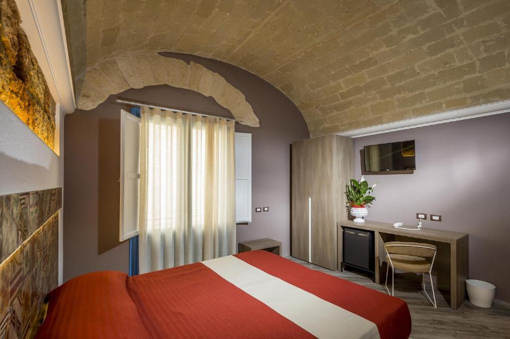 A bed or beds in a room at Hotel Vento del Sud