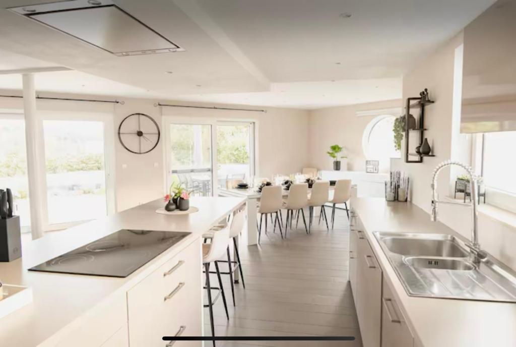 a kitchen with white countertops and white cabinets at La maison du Gouty in Froid-Chapelle
