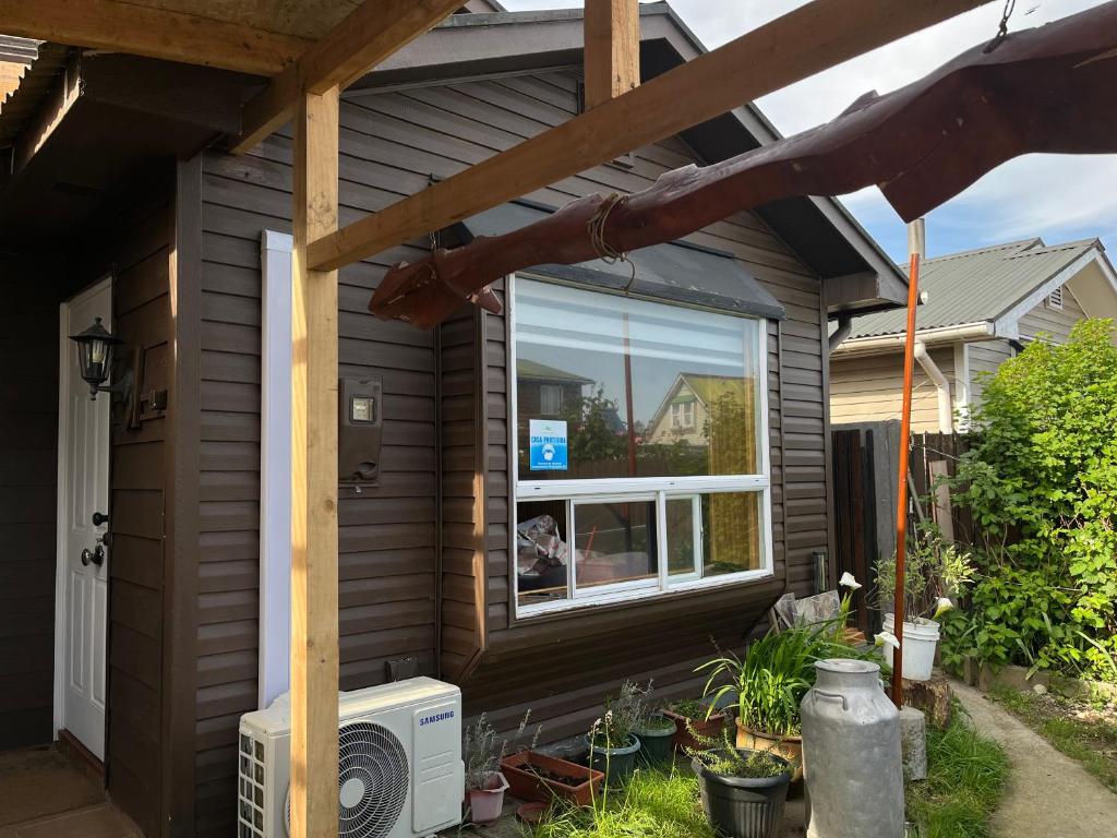 a house with a window on the side of it at Casa Amayita in Puerto Varas