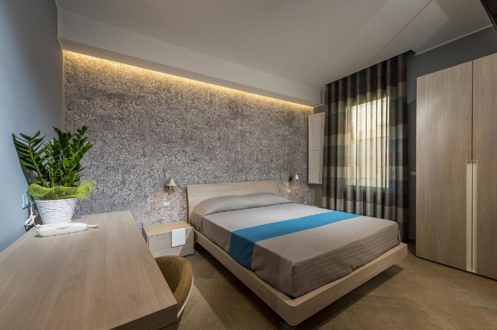 A bed or beds in a room at Hotel Vento del Sud