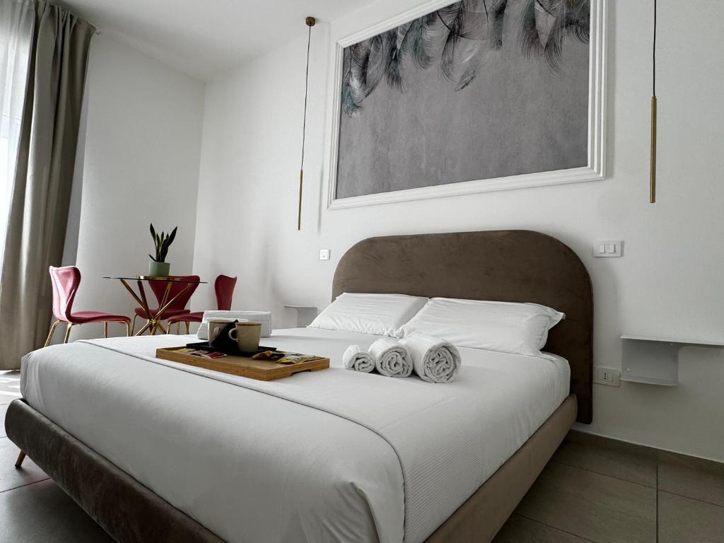 a bedroom with a bed with a tray of towels at Serèsia Rooms Siracusa Centro in Syracuse